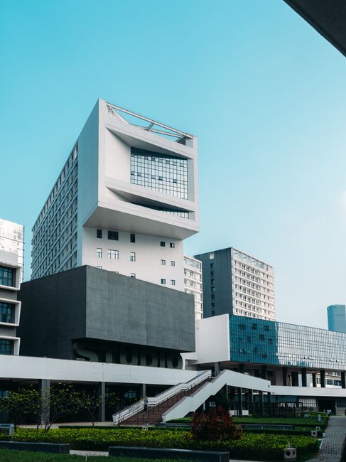 Contemporary urban office architecture against a clear blue sky, showcasing modern design