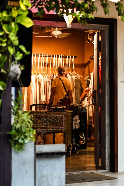 A cozy commercial retail boutique interior featuring fashionable clothing racks and modern layout