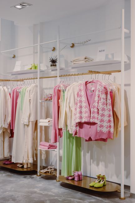 Stylish clothing display in a modern retail storefront with warm lighting and upscale decor